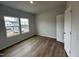 Bedroom with light wood flooring and two bright windows at 60 Cordoba Dr, Franklinton, NC 27525