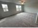 Large bedroom featuring carpet, a ceiling fan, and three large windows at 60 Cordoba Dr, Franklinton, NC 27525
