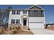 Charming two-story home with a mix of stone and siding, plus a two-car garage and nicely manicured lawn at 60 Cordoba Dr, Franklinton, NC 27525