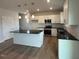 Stylish kitchen with white cabinets, stainless appliances, island with breakfast bar at 60 Cordoba Dr, Franklinton, NC 27525