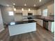 Modern kitchen features a large island, stainless steel appliances, and white cabinets at 60 Cordoba Dr, Franklinton, NC 27525