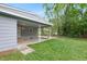 Exterior shot of the home's rear with covered porch and lush backyard at 621 Shepard School Rd, Zebulon, NC 27597