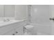 Bright bathroom with white cabinets, tile flooring, and a shower and tub combo at 621 Shepard School Rd, Zebulon, NC 27597