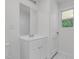 Clean bathroom featuring white cabinets, tile flooring, and a mirror at 621 Shepard School Rd, Zebulon, NC 27597