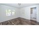 Bright bedroom with hardwood floors and built-in shelving at 621 Shepard School Rd, Zebulon, NC 27597