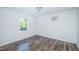 Simple bedroom with hardwood floors and a large window at 621 Shepard School Rd, Zebulon, NC 27597