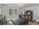 Cozy bedroom featuring neutral walls, a bed, a work station, and a decorative rug at 621 Shepard School Rd, Zebulon, NC 27597