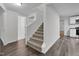 Bright entryway featuring a carpeted staircase, wood-look flooring, and fresh, neutral paint at 621 Shepard School Rd, Zebulon, NC 27597