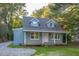 Charming blue house with a wood deck and well-maintained lawn at 621 Shepard School Rd, Zebulon, NC 27597