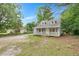 Charming two-story home with a covered porch and a gravel front yard at 621 Shepard School Rd, Zebulon, NC 27597