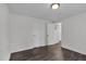 Hallway with wood look flooring, two doors and neutral paint and trim at 621 Shepard School Rd, Zebulon, NC 27597