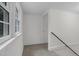 Neutral hallway featuring neutral carpet, white walls, and a staircase at 621 Shepard School Rd, Zebulon, NC 27597