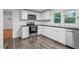 Modern kitchen with white cabinets, stainless steel appliances, and beautiful flooring at 621 Shepard School Rd, Zebulon, NC 27597