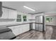 Spacious kitchen with stainless steel appliances, black countertops, and wood-look vinyl flooring at 621 Shepard School Rd, Zebulon, NC 27597