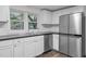 Updated kitchen boasting stainless steel appliances, white cabinets, and modern fixtures at 621 Shepard School Rd, Zebulon, NC 27597