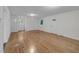Open living room featuring hardwood floors, neutral paint, and a bright front door at 621 Shepard School Rd, Zebulon, NC 27597