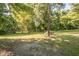 Large lot with mature trees and grassy area at 621 Shepard School Rd, Zebulon, NC 27597