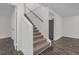 Staircase featuring neutral carpet, white walls, and hardwood floors at 621 Shepard School Rd, Zebulon, NC 27597
