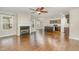 Spacious living room with hardwood floors, fireplace, and kitchen views at 6390 Cane Creek Rd, Snow Camp, NC 27349