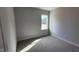 Cozy bedroom featuring plush carpeting, neutral walls, and a bright window at 65 Leisure Ln, Louisburg, NC 27549