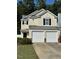 Two-story house with double garage and landscaped yard at 7309 Brighton Hill Ln, Raleigh, NC 27616