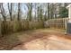 Fenced backyard with a concrete patio and mature trees provides privacy at 749 Swan Neck Ln, Raleigh, NC 27615