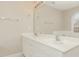 Bright bathroom featuring a double vanity with modern fixtures, a large mirror, and a window over the tub at 749 Swan Neck Ln, Raleigh, NC 27615