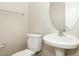 Bathroom featuring a pedestal sink, toilet, and neutral decor at 749 Swan Neck Ln, Raleigh, NC 27615