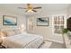 Stylized bedroom featuring warm neutral walls, plush bedding, side tables and natural light from two windows at 749 Swan Neck Ln, Raleigh, NC 27615