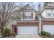 Charming two-story home with brick accents, red shutters, and a two-car garage at 749 Swan Neck Ln, Raleigh, NC 27615
