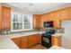 Well-equipped kitchen with light wood cabinets and mosaic backsplash at 749 Swan Neck Ln, Raleigh, NC 27615