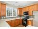 Well-equipped kitchen with wood cabinets, modern appliances, and bright countertops at 749 Swan Neck Ln, Raleigh, NC 27615