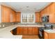 Well-equipped kitchen with wood cabinets, modern appliances, and bright countertops at 749 Swan Neck Ln, Raleigh, NC 27615