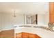 Kitchen featuring wood cabinets, modern appliances, and easy access to the living room at 749 Swan Neck Ln, Raleigh, NC 27615