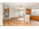 Open-concept kitchen featuring wood cabinets, modern appliances, and convenient access to living areas at 749 Swan Neck Ln, Raleigh, NC 27615