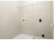 Bright laundry room with hookups, shelf, and space for washer and dryer at 749 Swan Neck Ln, Raleigh, NC 27615
