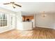 Open concept living room with wood flooring, ceiling fan, and easy access to the adjacent kitchen at 749 Swan Neck Ln, Raleigh, NC 27615