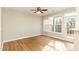 Bright living room featuring wood floors, a ceiling fan, and ample natural light at 749 Swan Neck Ln, Raleigh, NC 27615