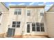 Tan house exterior with multiple windows and a back patio at 749 Swan Neck Ln, Raleigh, NC 27615