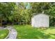 Backyard with shed, firepit, and stone pathway at 816 Peyton St, Raleigh, NC 27610