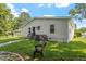 Back of house with pathway, lawn, and AC unit at 816 Peyton St, Raleigh, NC 27610