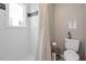 Clean bathroom with shower, toilet, and neutral tile at 816 Peyton St, Raleigh, NC 27610