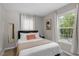 Well-lit bedroom with queen bed and large window at 816 Peyton St, Raleigh, NC 27610