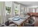Modern dining area with marble table and gold chairs, overlooking the front yard at 816 Peyton St, Raleigh, NC 27610