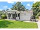 Charming white brick ranch home with a covered porch and well-maintained lawn at 816 Peyton St, Raleigh, NC 27610