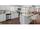 Open concept kitchen features a large island with seating and stainless steel appliances at 816 Peyton St, Raleigh, NC 27610