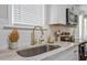 Modern kitchen sink with gold faucet and white subway tile backsplash at 816 Peyton St, Raleigh, NC 27610