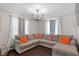 Spacious living room featuring a large sectional sofa and stylish chandelier at 816 Peyton St, Raleigh, NC 27610