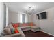 Living room with L-shaped sectional sofa and chandelier at 816 Peyton St, Raleigh, NC 27610