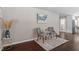 Cozy sitting area with two armchairs, side table, and stylish wall art at 816 Peyton St, Raleigh, NC 27610